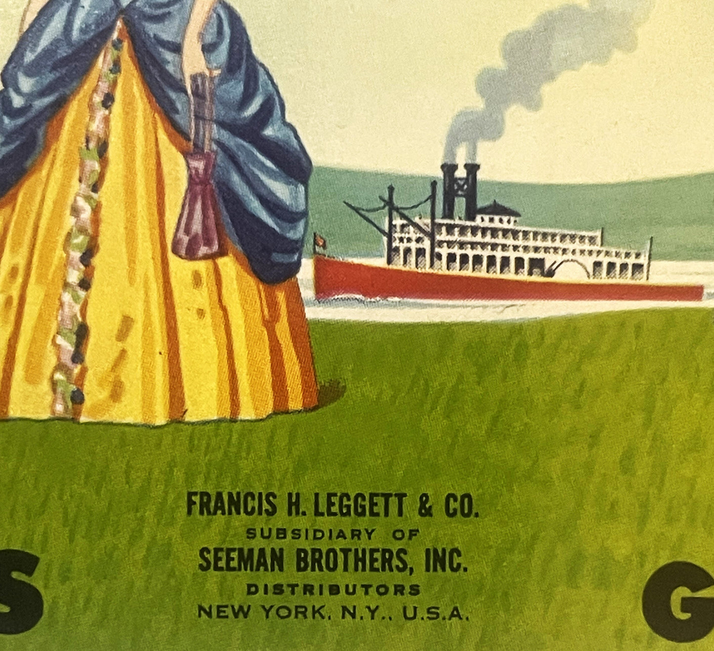Vintage steamboat can label showing woman in yellow and blue dress viewing paddlewheel riverboat, printed by Francis H. Legge