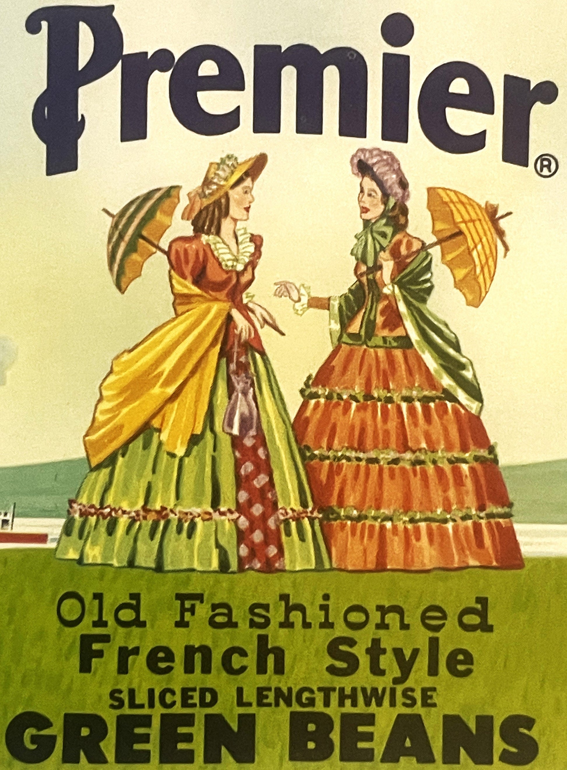 Vintage Premier green beans can label featuring two Victorian ladies in colorful dresses with parasols against cream and gree