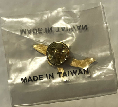 Small brass aviation lapel pin with profile portrait in clear plastic packet labeled "MADE IN TAIWAN" with gold mesh wings vi