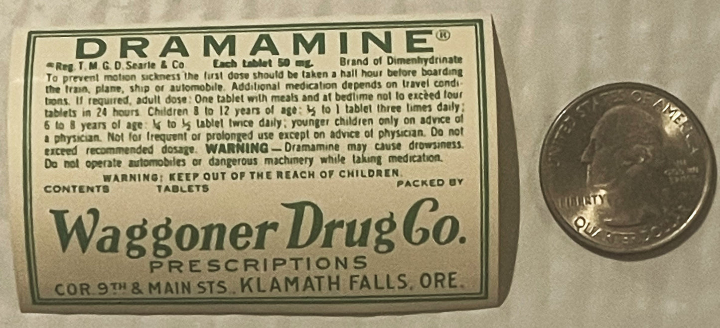 Vintage Dramamine tablet label from Waggoner Drug Co, Klamath Falls OR, next to a penny for scale