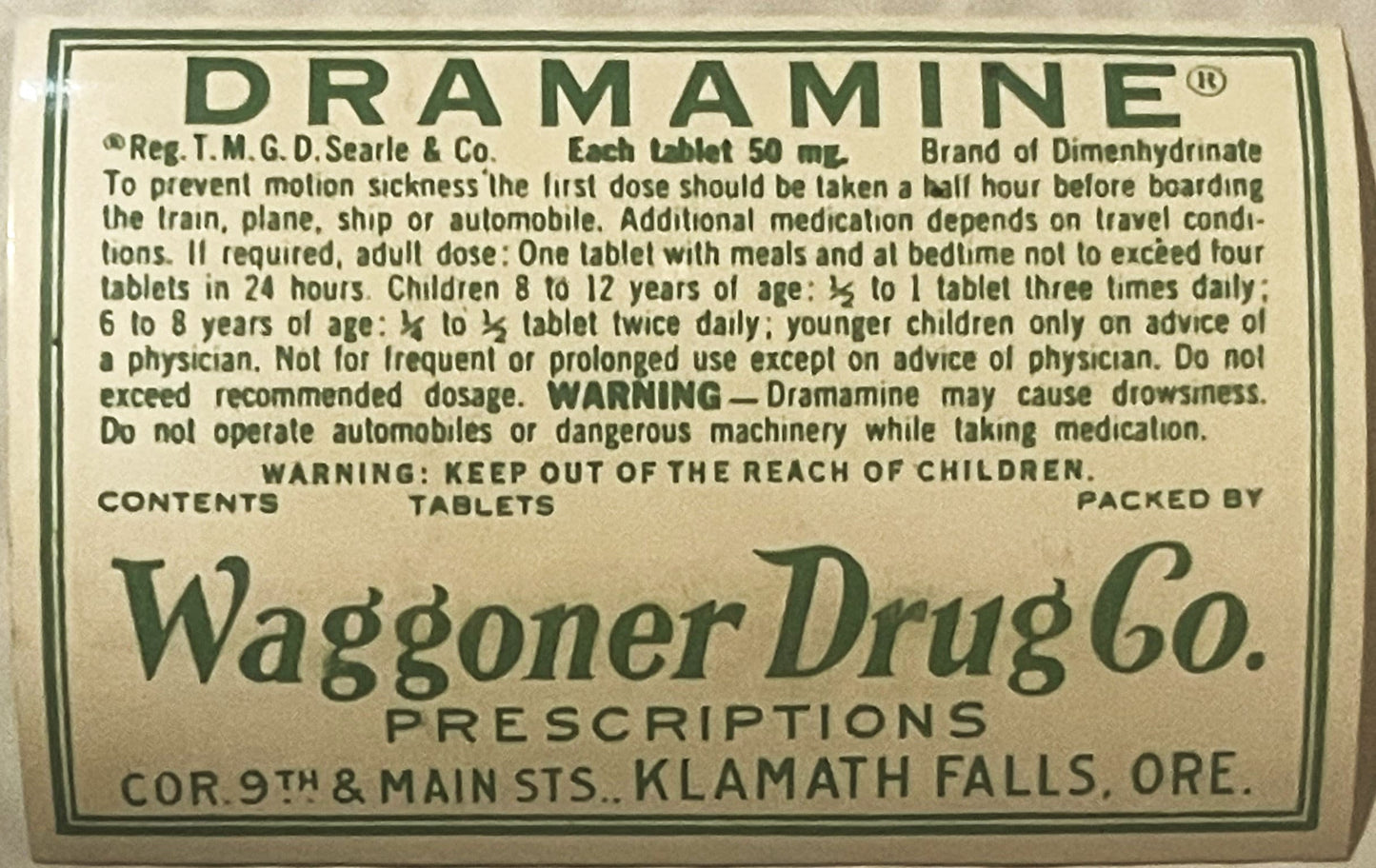 Vintage Dramamine tablet label from Waggoner Drug Co in Klamath Falls, Oregon, with green text on cream background and dosage