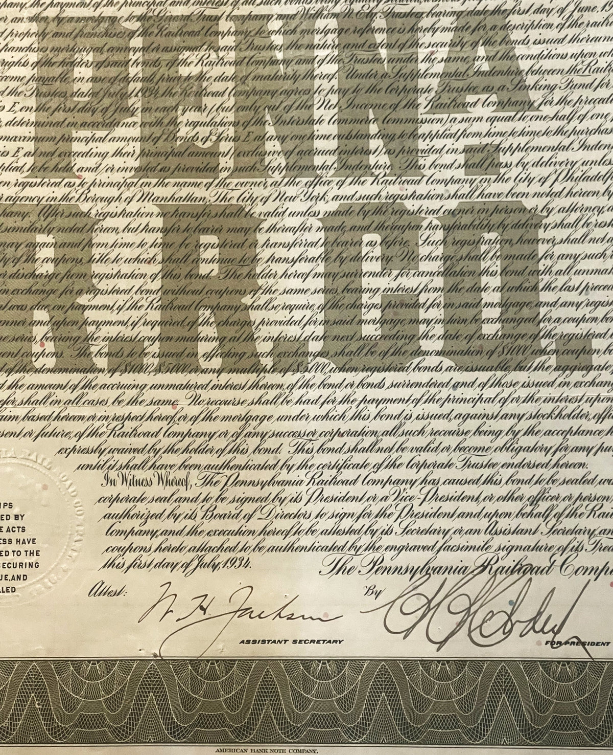 Vintage 1934 Pennsylvania Railroad $1000 gold bond document with ornate borders, signatures, and decorative coupon sheet at b