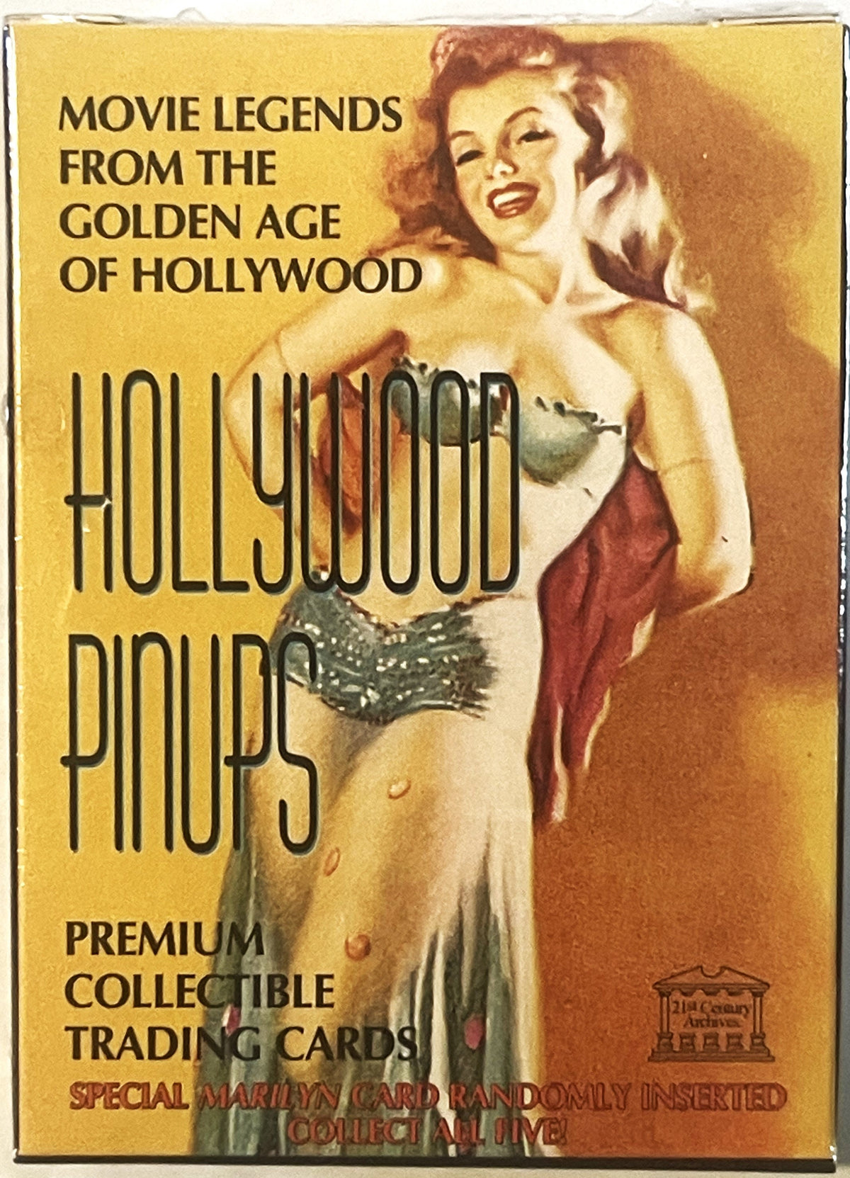 Sealed box of vintage Hollywood pinup trading cards featuring a red-haired woman in gold and red tones against yellow backgro