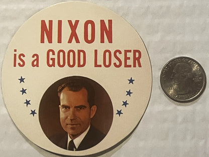 Vintage political sticker with "NIXON is a GOOD LOSER" text, portrait photo, and stars, displayed next to a quarter for scale