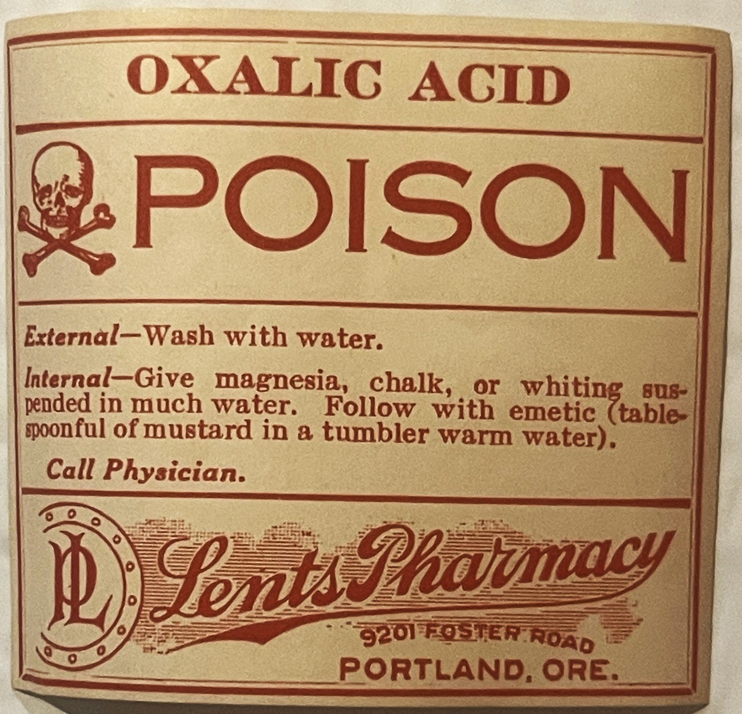 Vintage poison label for oxalic acid from Lents Pharmacy in Portland, Oregon, with skull and crossbones symbol and red text o