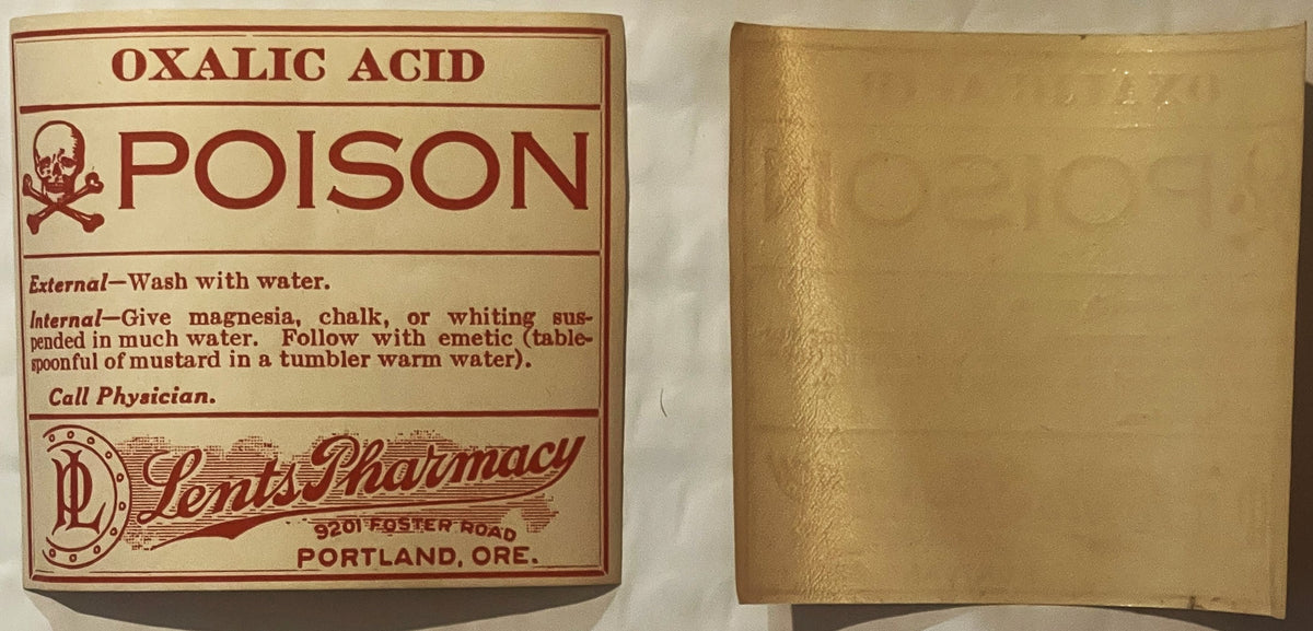 Vintage oxalic acid poison label from Lents Pharmacy in Portland with skull and crossbones symbol, shown front and back on cr