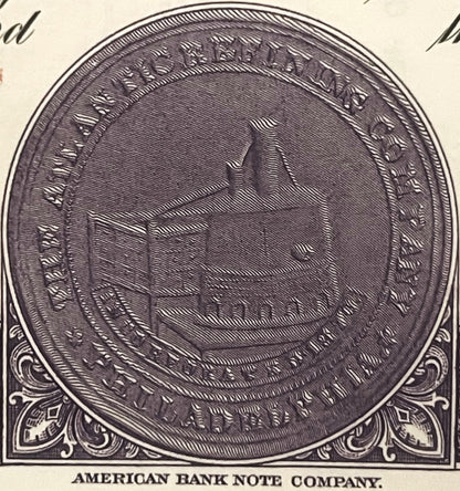 Black and white engraved circular seal from American Bank Note Company showing detailed line work and ornamental corners on c