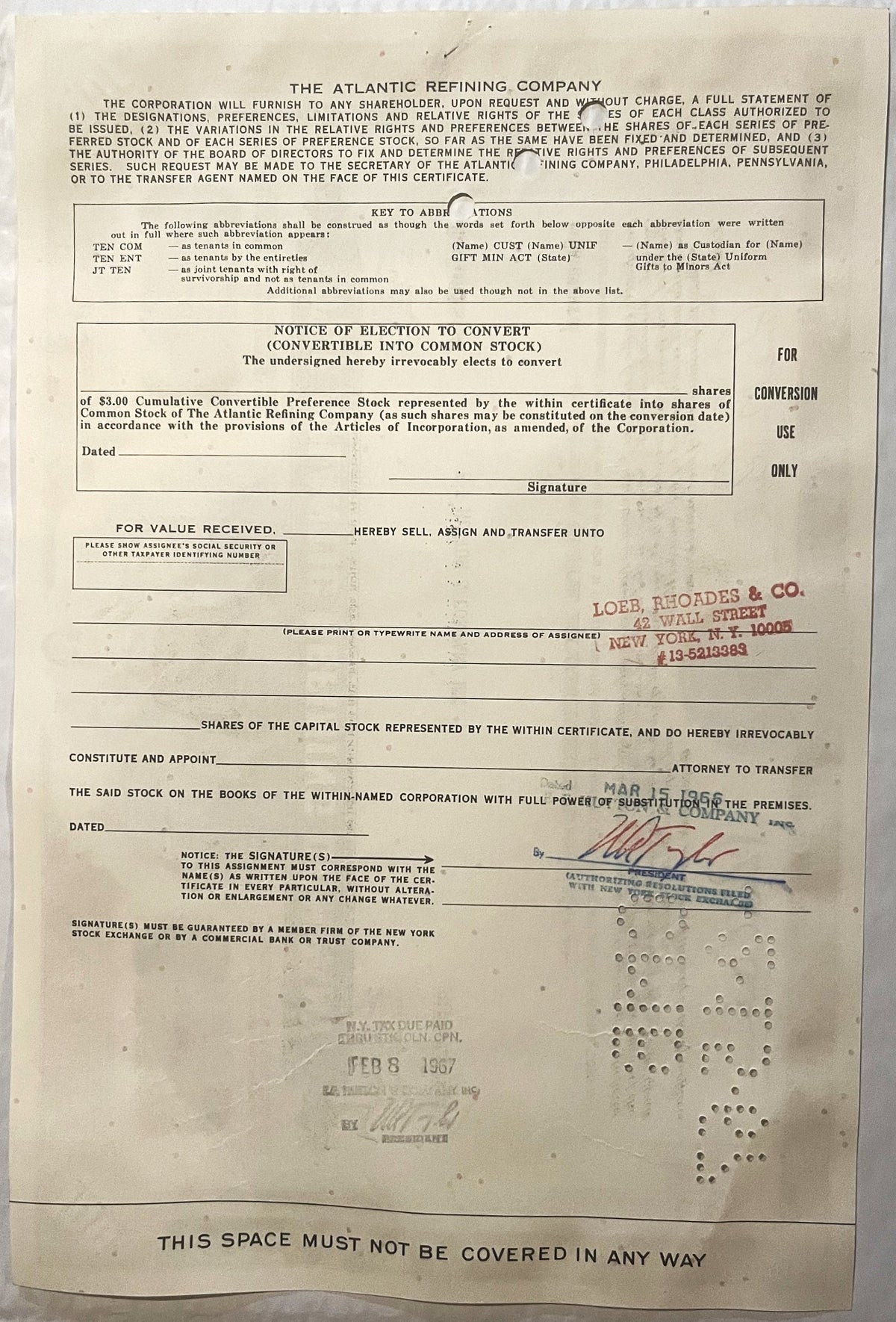 Yellowed 1960s Atlantic Refining Company stock certificate with printed text, conversion notice, and red stamp from Loeb, Rho