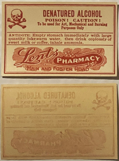 Vintage denatured alcohol poison label from Lents Pharmacy with skull and crossbones symbol, front and back sides shown on ta
