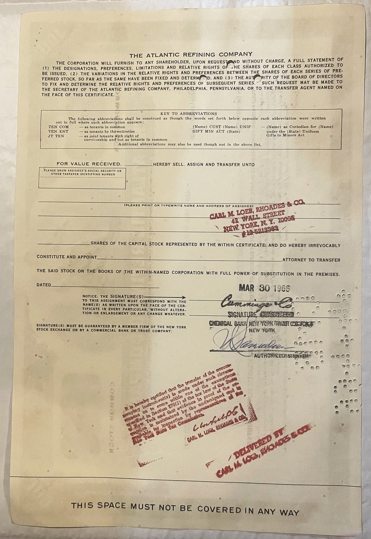 Cream-colored Atlantic Refining Company stock certificate with red stamps, signatures, and company seals, dated MAR 30 1