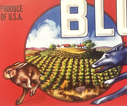 Vintage produce crate label with red background showing a greyhound dog, rabbit, and farmland scene, text reads "PRODUCE OF U