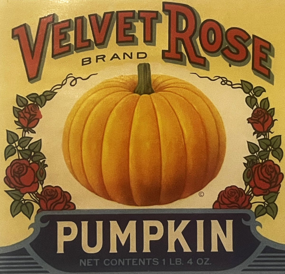 Vintage Velvet Rose Brand pumpkin can label with large orange pumpkin centered, red roses and vines framing sides, 1 LB. 4 OZ
