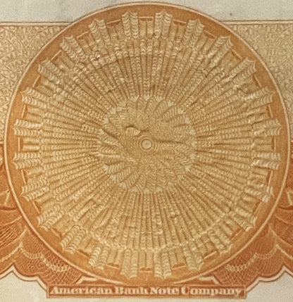 Embossed circular orange certificate design with radiating feather pattern and "American Bank Note Company" text at bottom
