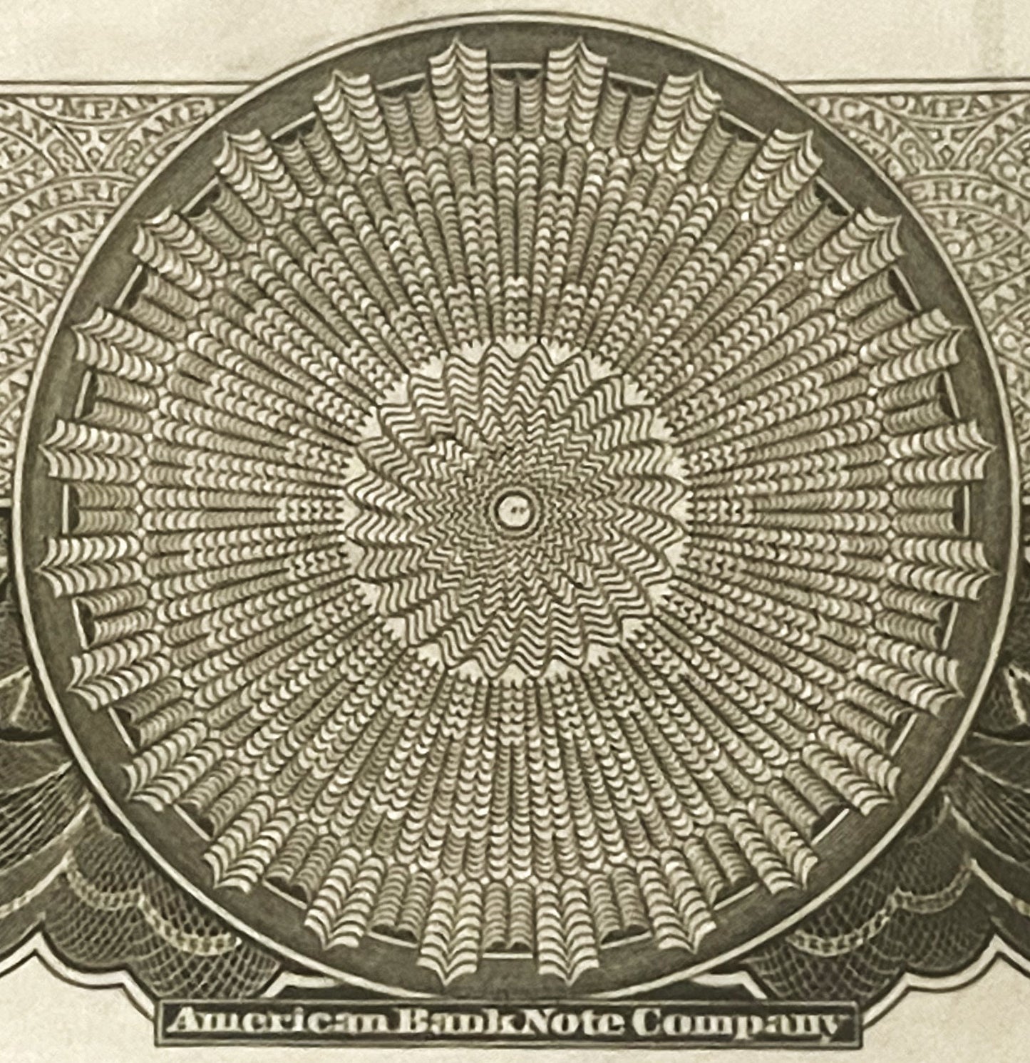 Close-up of intricate circular geometric pattern from American Bank Note Company stock certificate vignette, printed in green