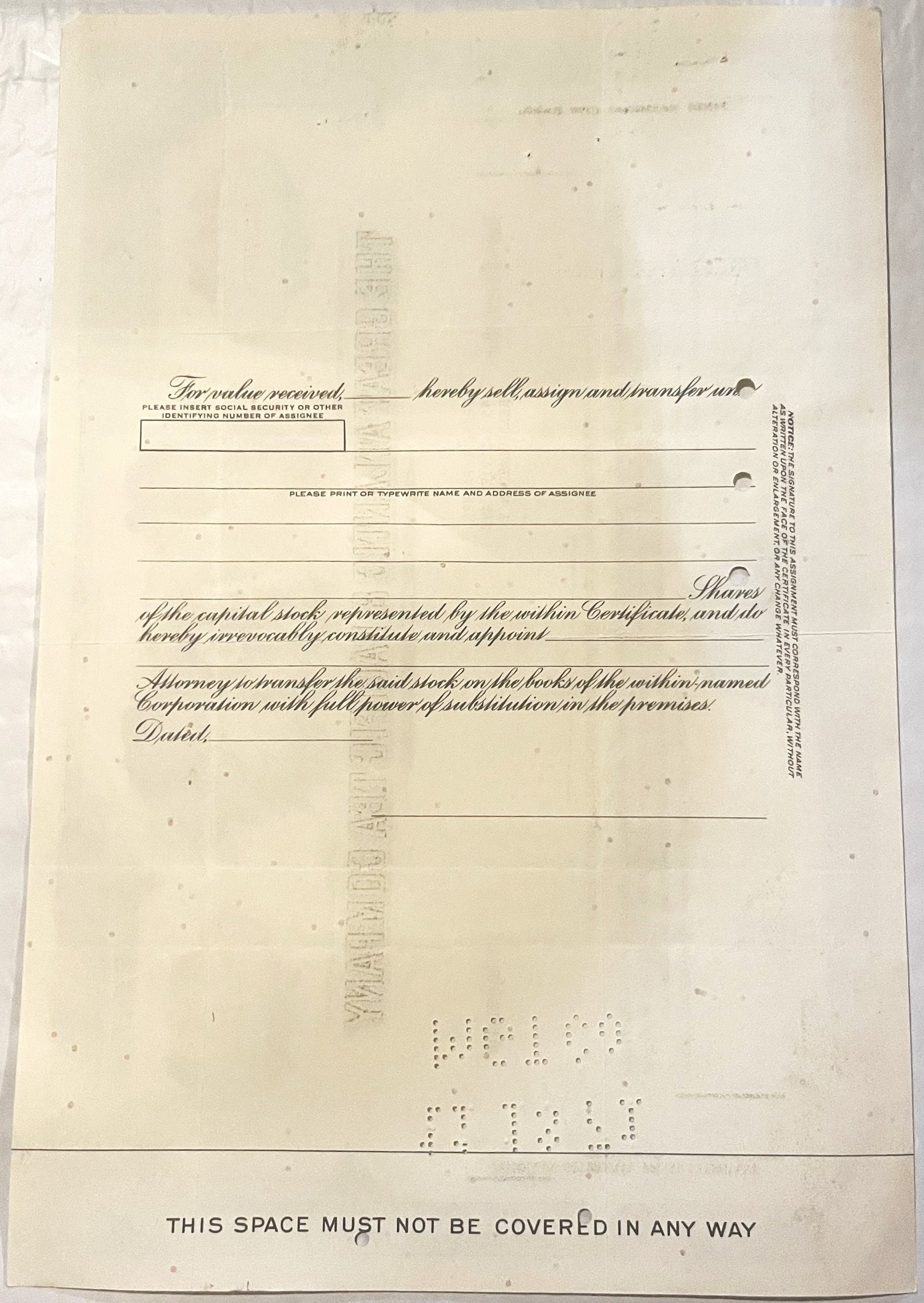 Blank vintage stock certificate form with ornate cursive text and printed instructions, cream-colored paper with braille at b