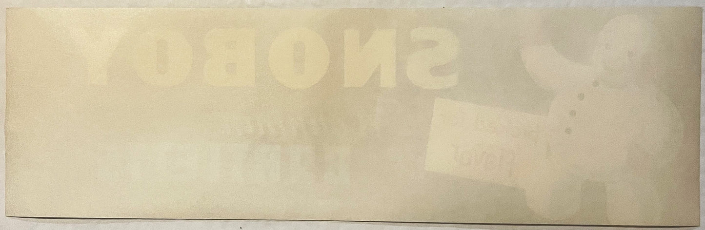 Faded vintage Snoboy snowman crate label with embossed text on cream-colored paper, photographed flat from above