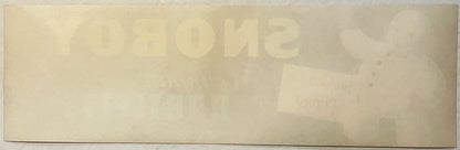 Faded vintage Snoboy snowman crate label with embossed text on cream-colored paper, photographed flat from above
