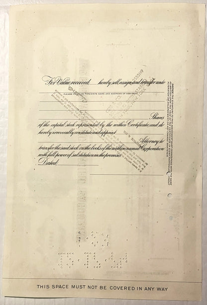 Yellowed vintage stock certificate form with ornate cursive text, blank lines for assignee information, and "THIS SPACE MUST 