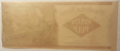 Faded vintage tomato pulp can label with embossed diamond-shaped logo reading "Wissahickon" on tan paper background