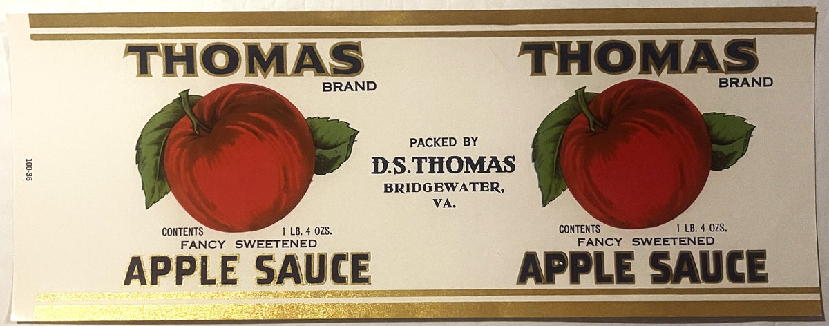 Antique Thomas Brand apple sauce can label from Bridgewater, VA, featuring red apple illustration, gold text, and cream background. Two identical label designs shown side by side.
