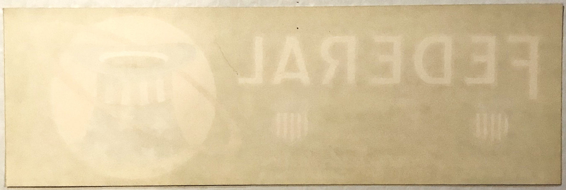 Faded vintage crate label with "PATRIOT" text visible at top, cream-colored paper with embossed or printed lettering, photogr