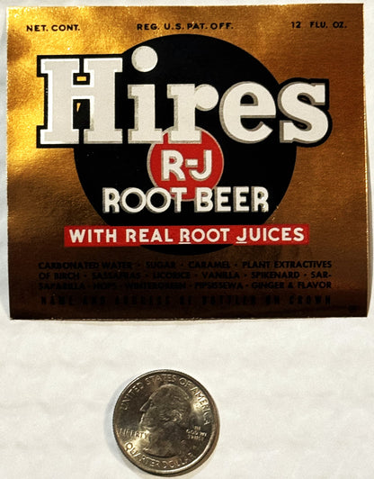Vintage Hires R-J Root Beer label with gold background and black circle logo, shown next to quarter for scale