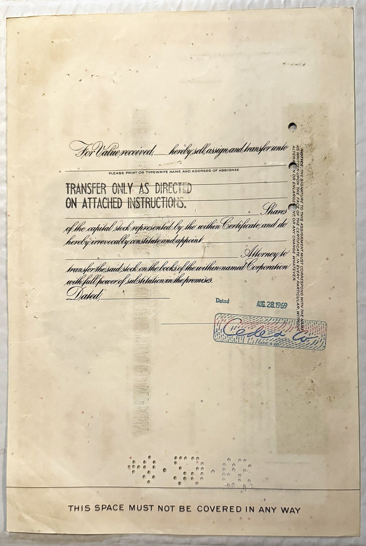 Aged stock certificate form, with handwritten cursive text, transfer instructions, and signature stamp