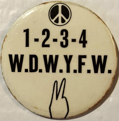 Cream-colored round pinback button with peace symbol at top, "1-2-3-4 W.D.W.Y.F.W." text, peace hand gesture at bottom, shown