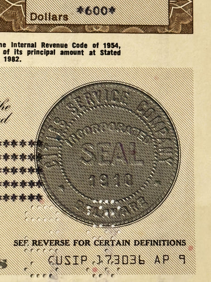 Close-up of vintage stock certificate showing circular seal with eagle emblem and text referencing Internal Revenue Code of 1