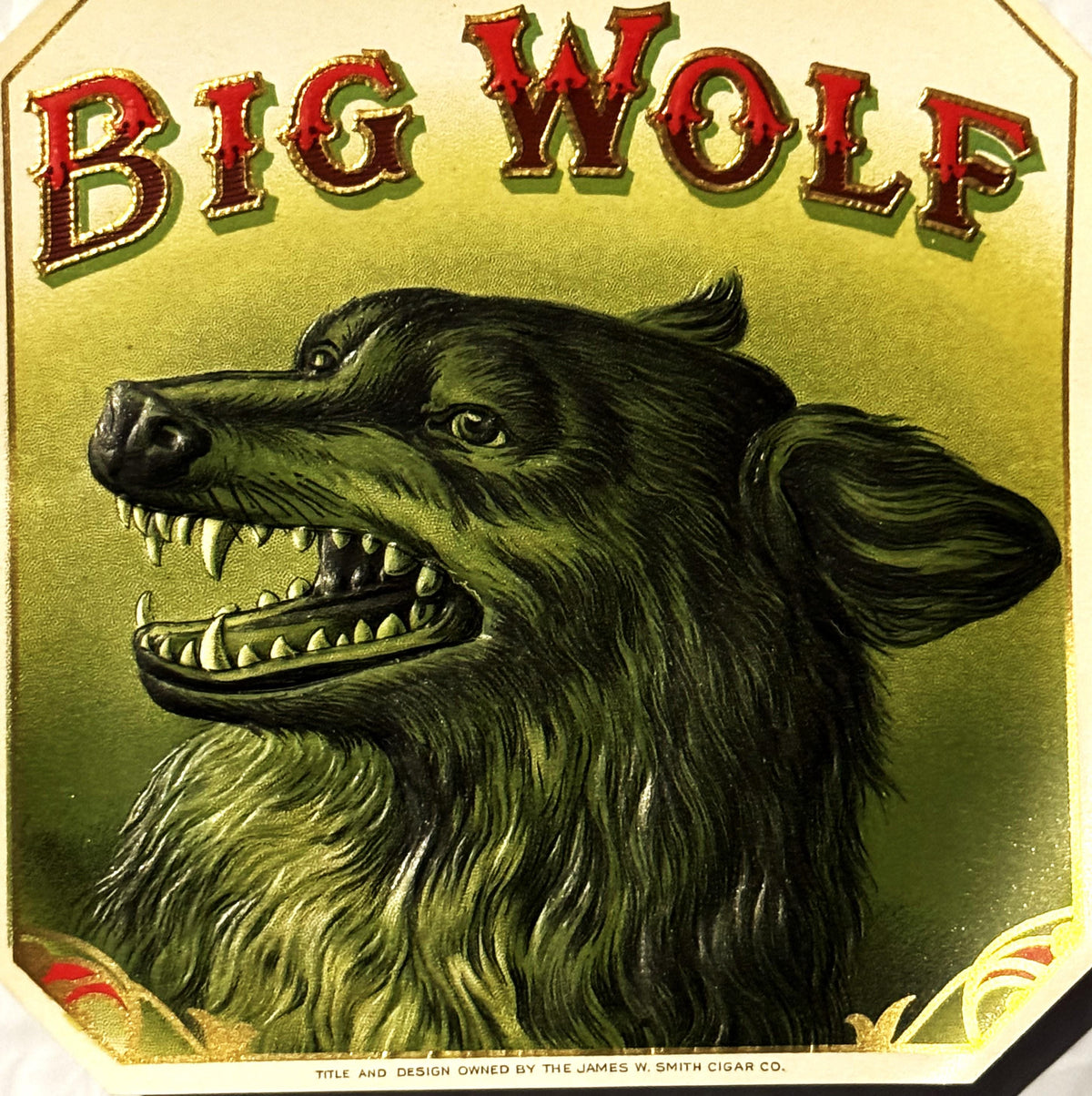 Antique "Big Wolf" cigar label with gold-embossed chromolithograph featuring a snarling green wolf's head on yellow backgroun