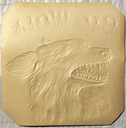 Cream-colored embossed cigar label featuring a wolf's head in profile with detailed fur texture and bared teeth, text visible