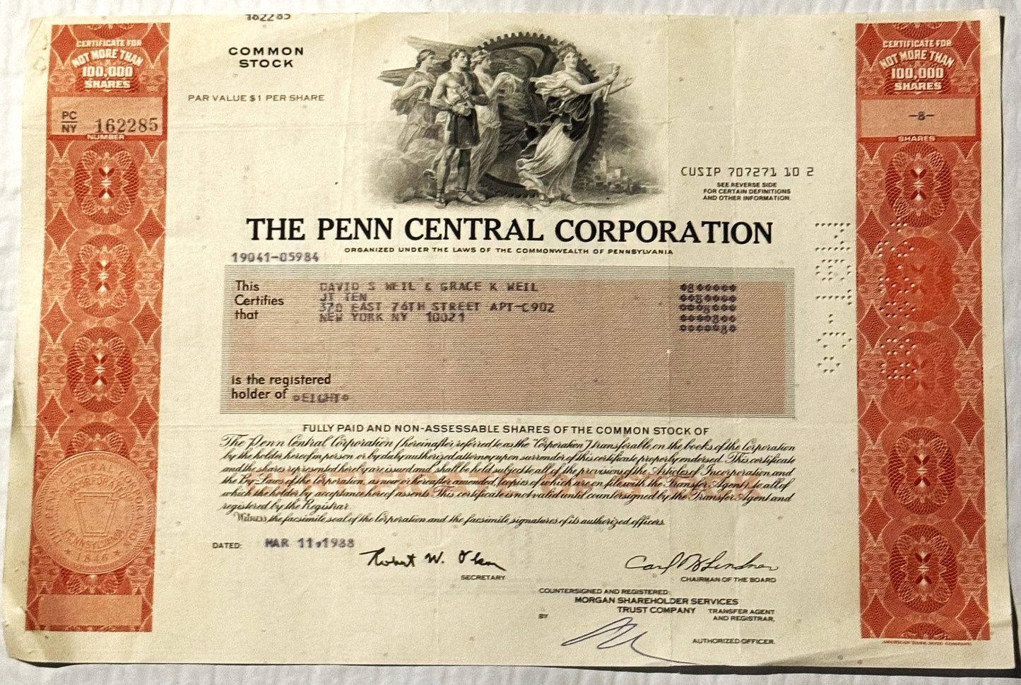Vintage Penn Central Corporation stock certificate from with ornate red borders, central engraving of classical figures
