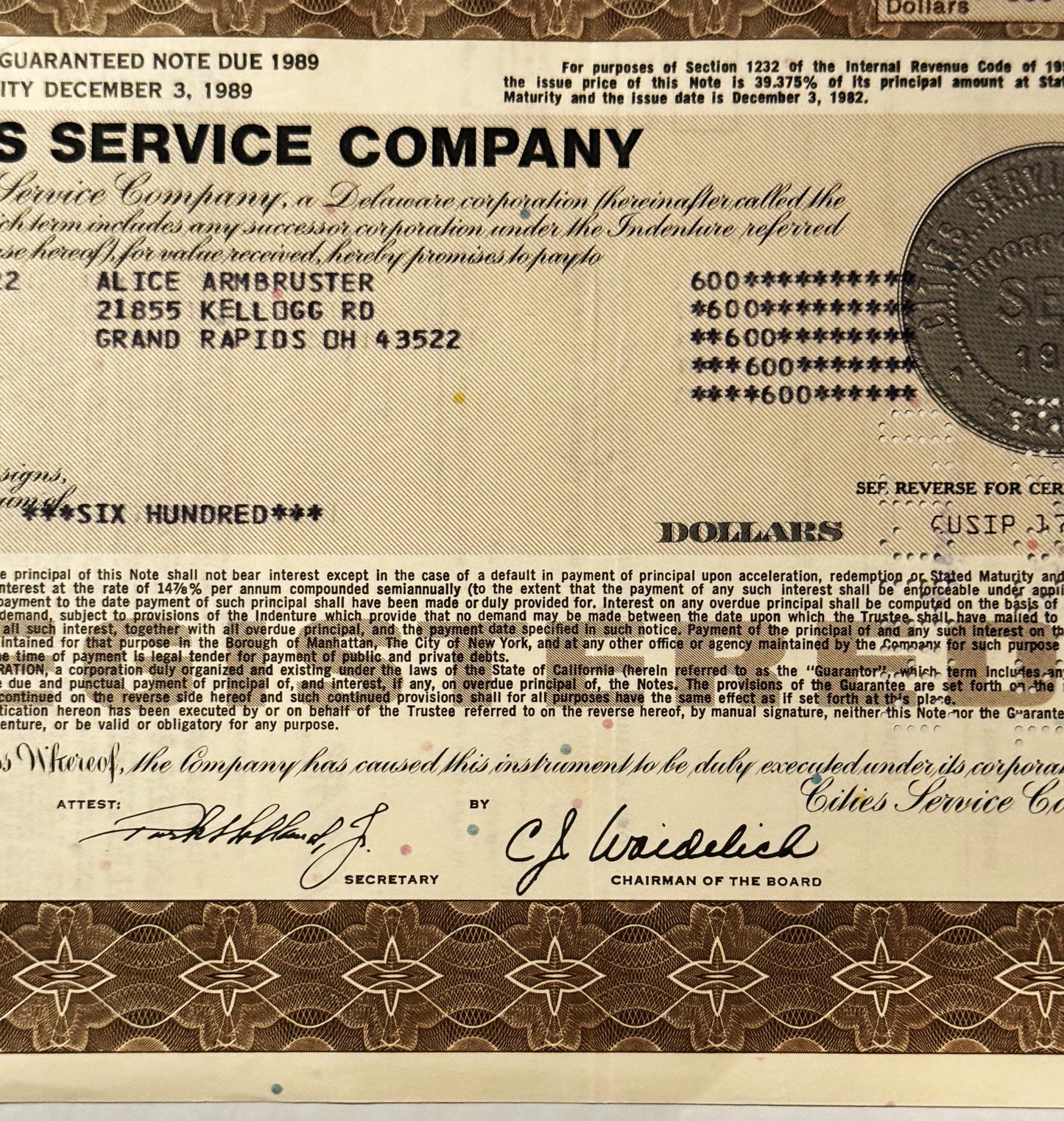 Vintage Cities Service Company stock certificate with tan and brown security printing, showing payee name and address in
