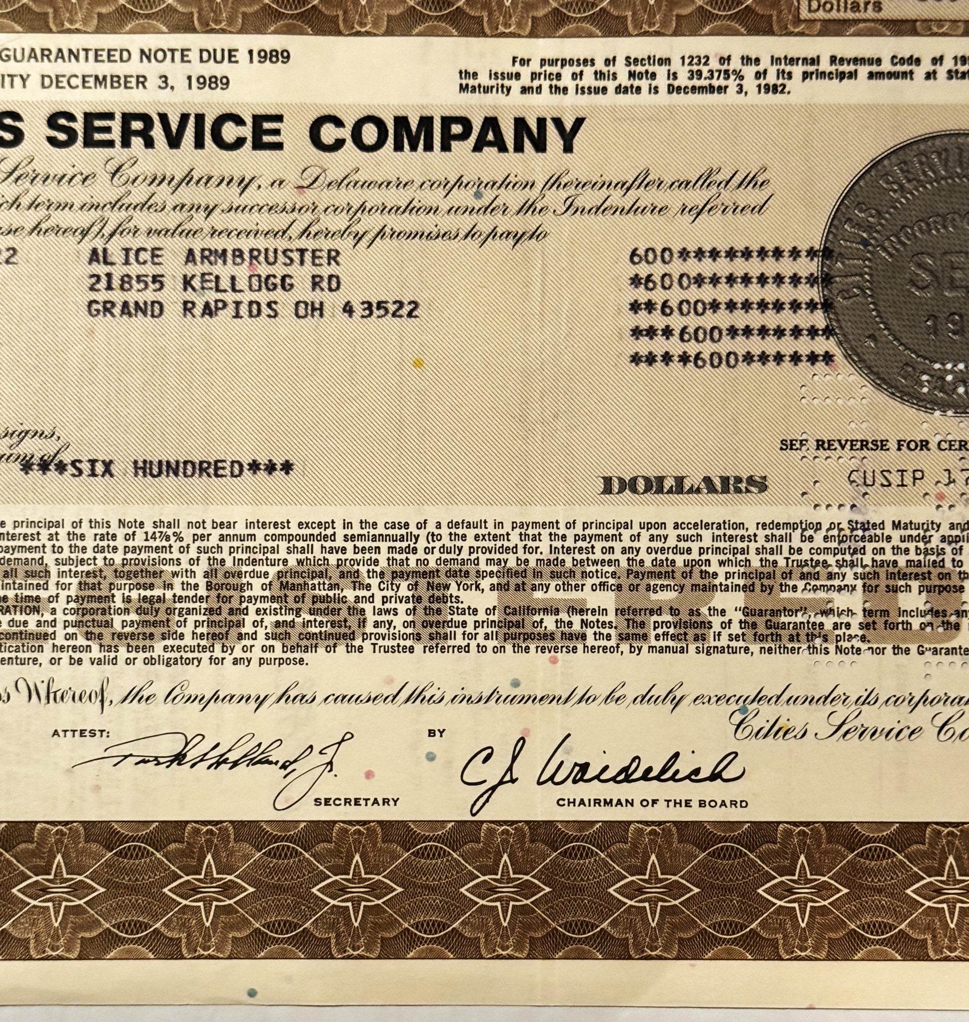 Vintage Cities Service Company stock certificate with tan and brown security printing, showing payee name and address in