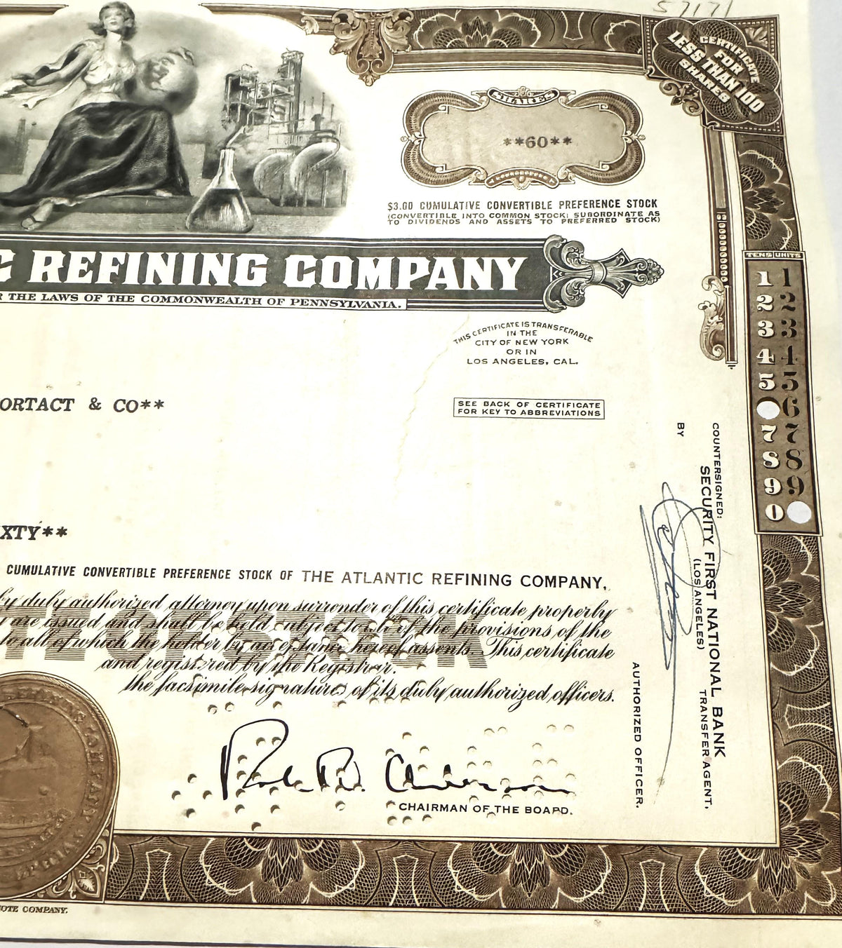 Vintage stock certificate from Atlantic Refining Company featuring ornate border design, allegorical woman illustration, indu