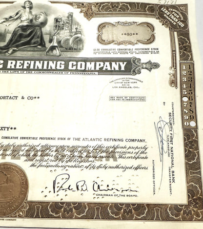 Vintage stock certificate from Atlantic Refining Company featuring ornate border design, allegorical woman illustration, indu
