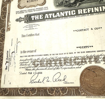 Atlantic Refining Company stock certificate with decorative border, signature, and penny for scale
