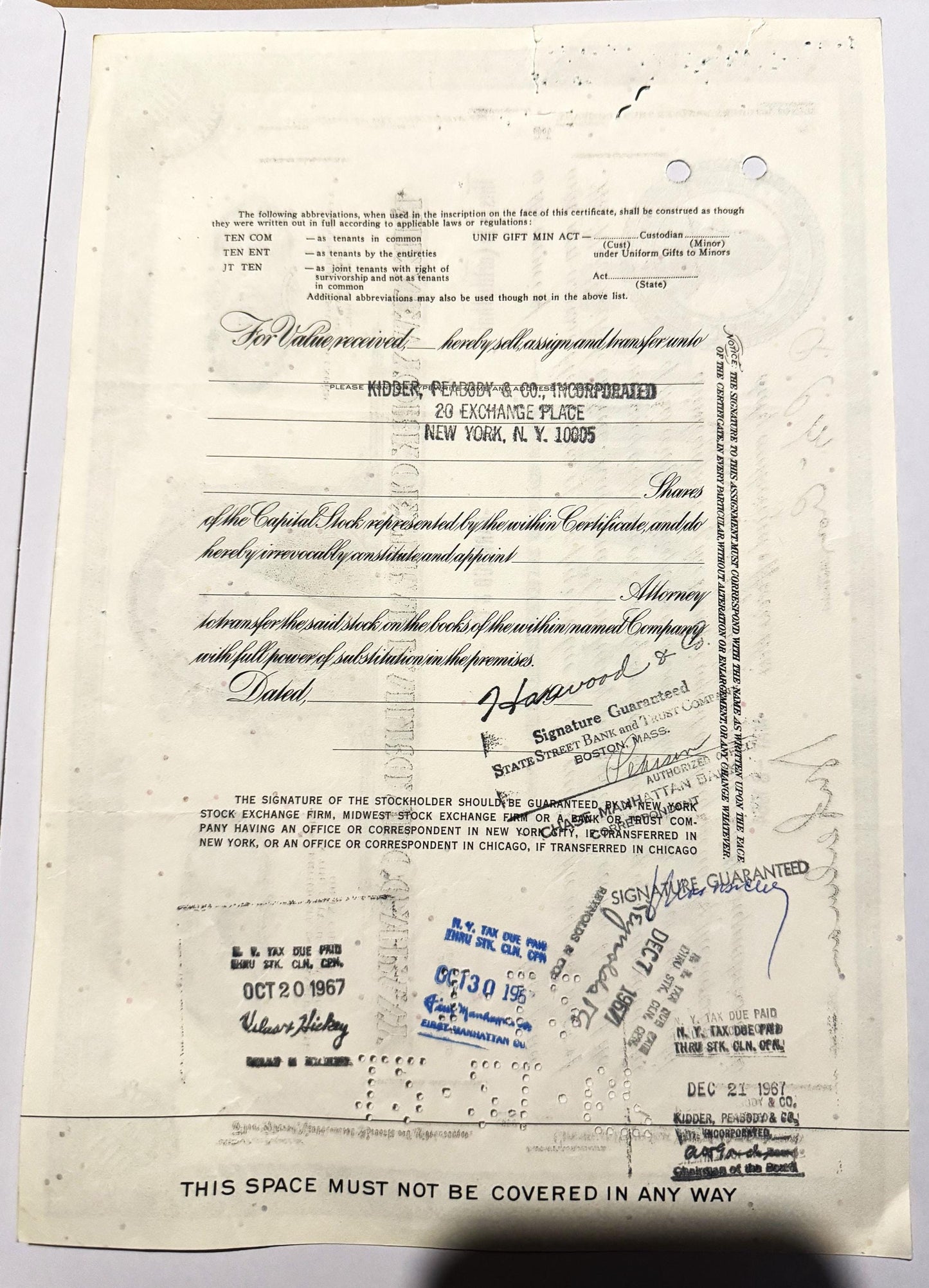 Aged stock certificate from Kidder, Peabody & Co. with blue ink stamps, signatures, and railroad company details v