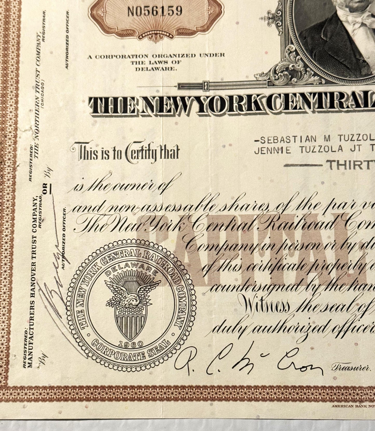 Vintage New York Central Railroad stock certificate from with brown border, corporate seal, and handwritten signatures