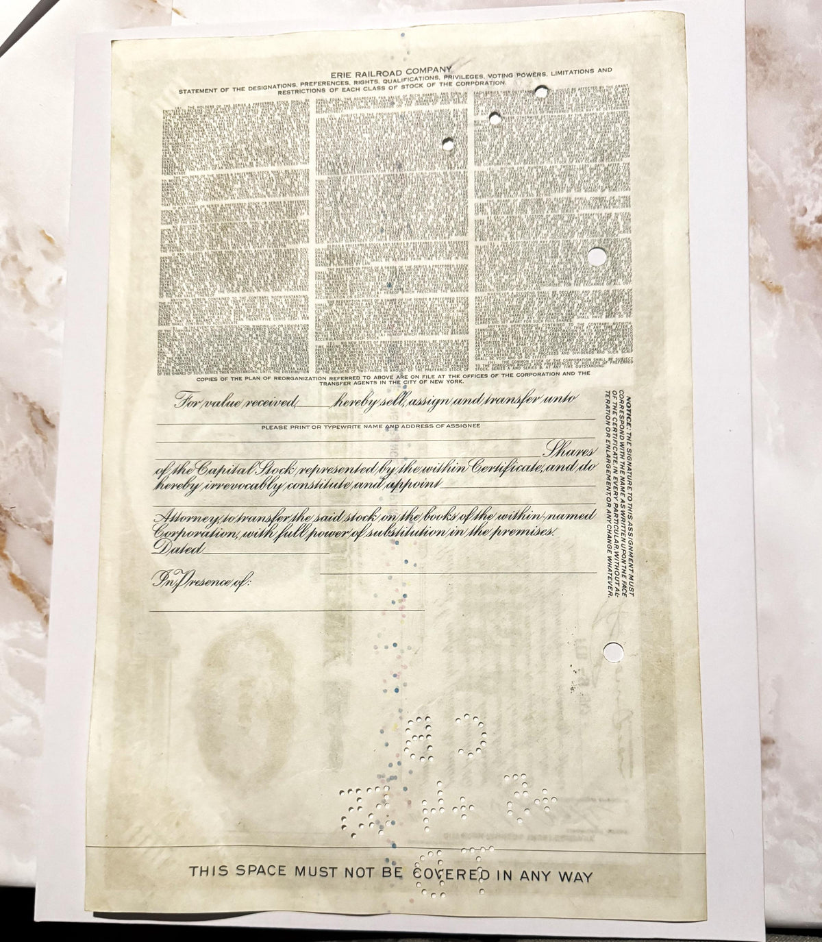 Aged cream-colored Erie Railroad stock certificate form with dense printed text in three columns, blank signature lines, and 
