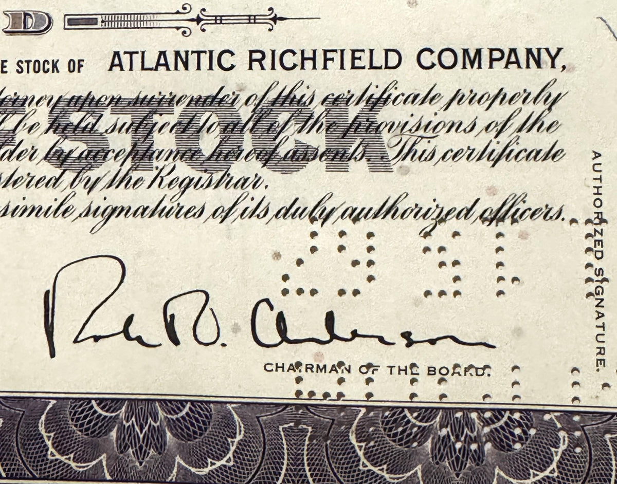 Vintage Atlantic Richfield Company stock certificate with printed text, decorative border, and handwritten signature of Chair