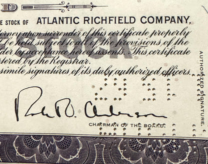 Vintage Atlantic Richfield Company stock certificate with printed text, decorative border, and handwritten signature of Chair