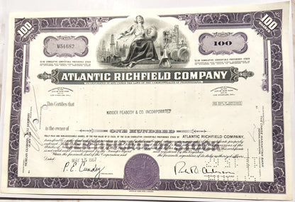 Vintage Atlantic Richfield Company stock certificate for 100 shares, purple and cream colored with ornate borders and ce