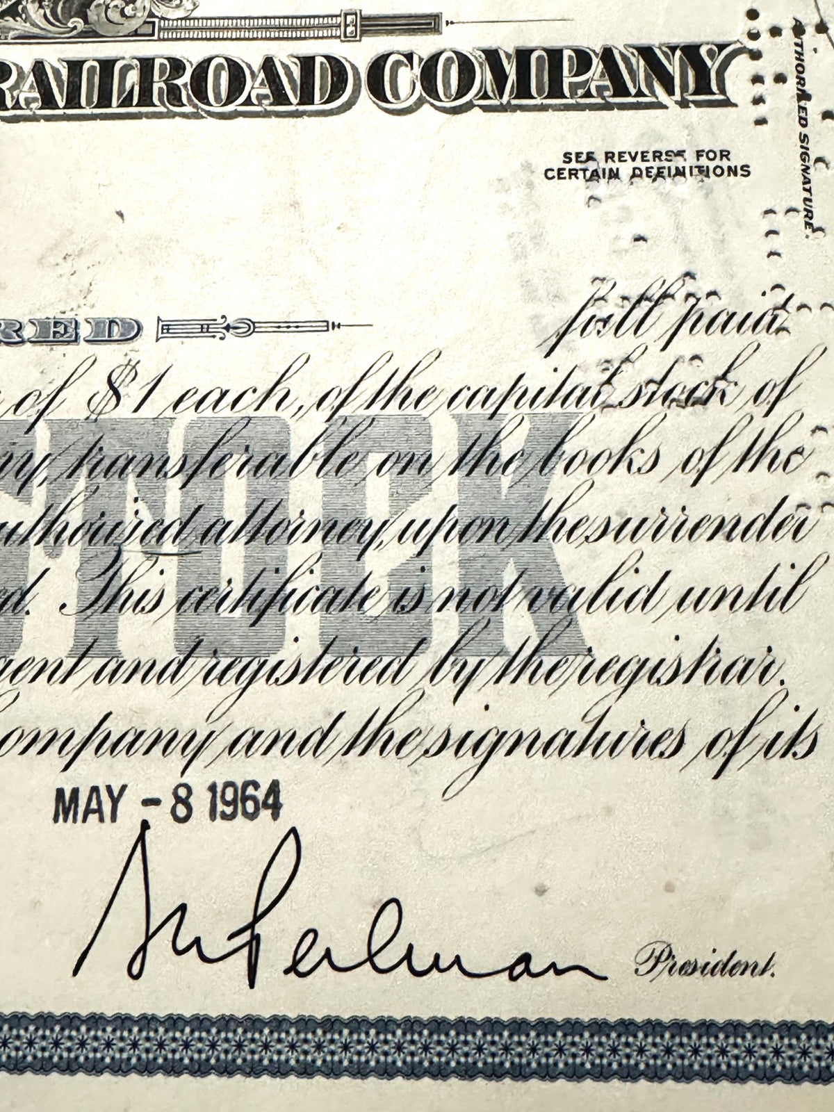 Vintage New York Central Railroad stock certificate with blue ornamental header, handwritten cursive text, and signature