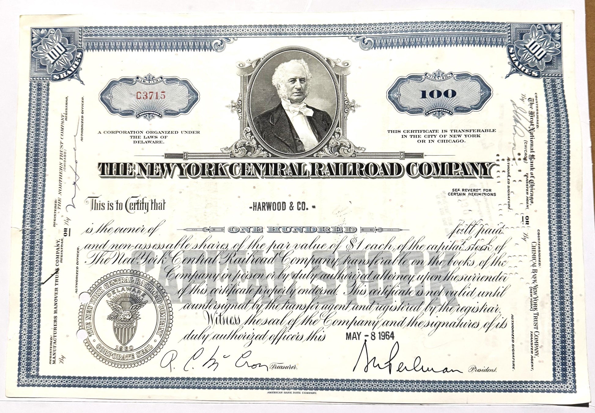 Vintage New York Central Railroad stock certificate for 100 shares, featuring portrait and blue ornamental border design