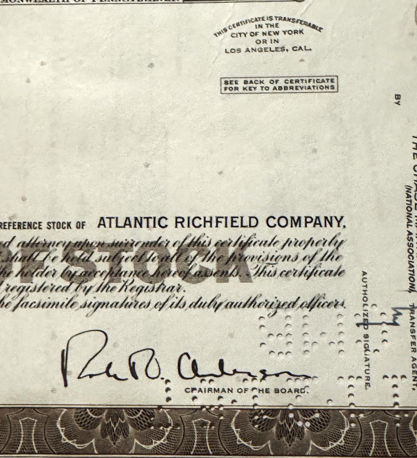 Vintage Atlantic Richfield Company stock certificate with brown decorative border and handwritten signature of Chairman of th