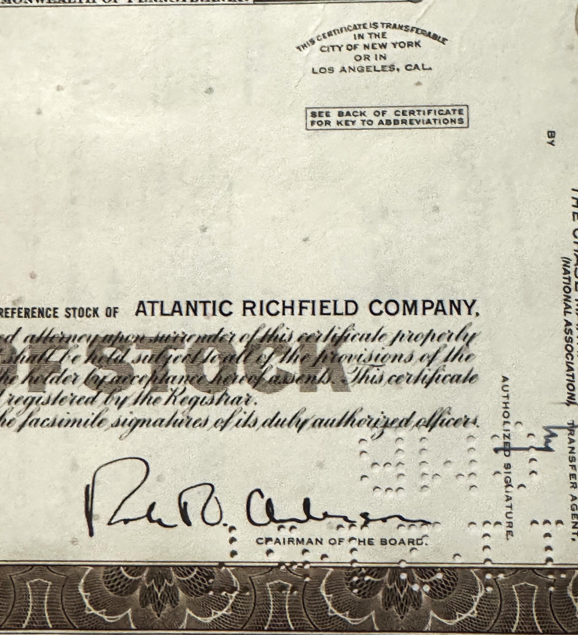 Vintage Atlantic Richfield Company stock certificate with brown decorative border and handwritten signature of Chairman of th