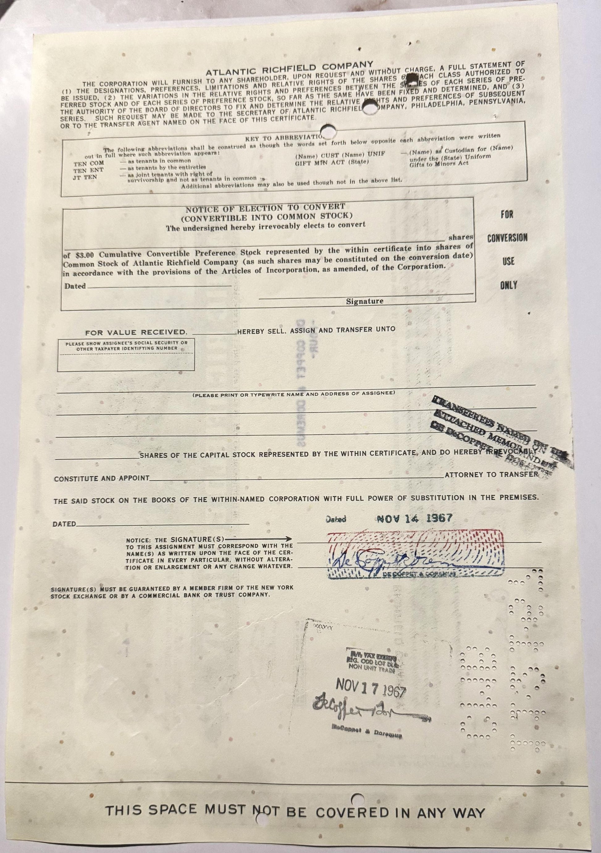 Cream-colored Atlantic Richfield convertible stock certificate with printed text, signature, and dated stamps in blue an