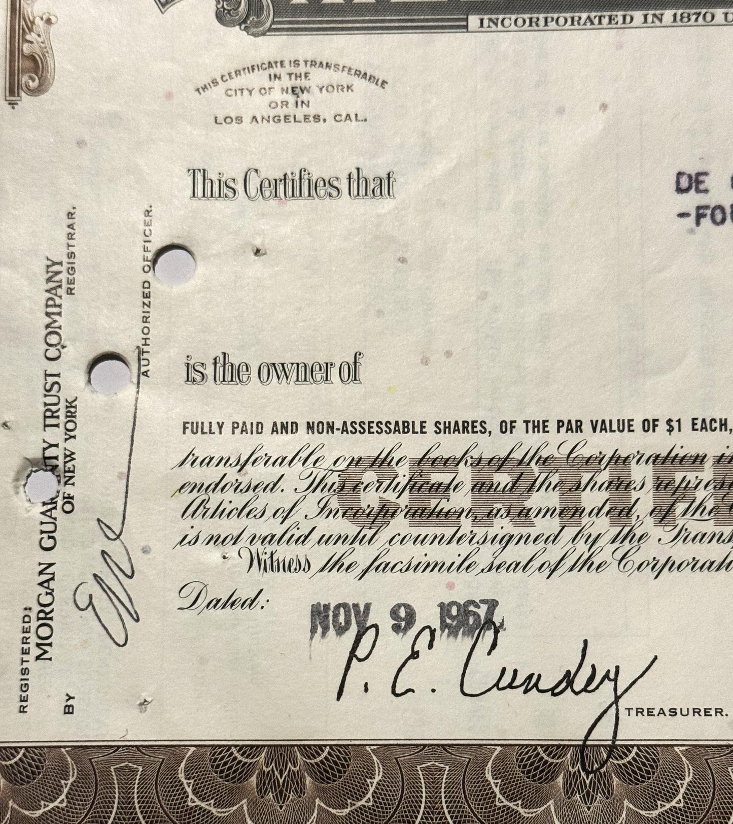 Close-up of vintage stock certificate dated Nov 9, showing Morgan Guaranty Trust Company header, printed text certifyin