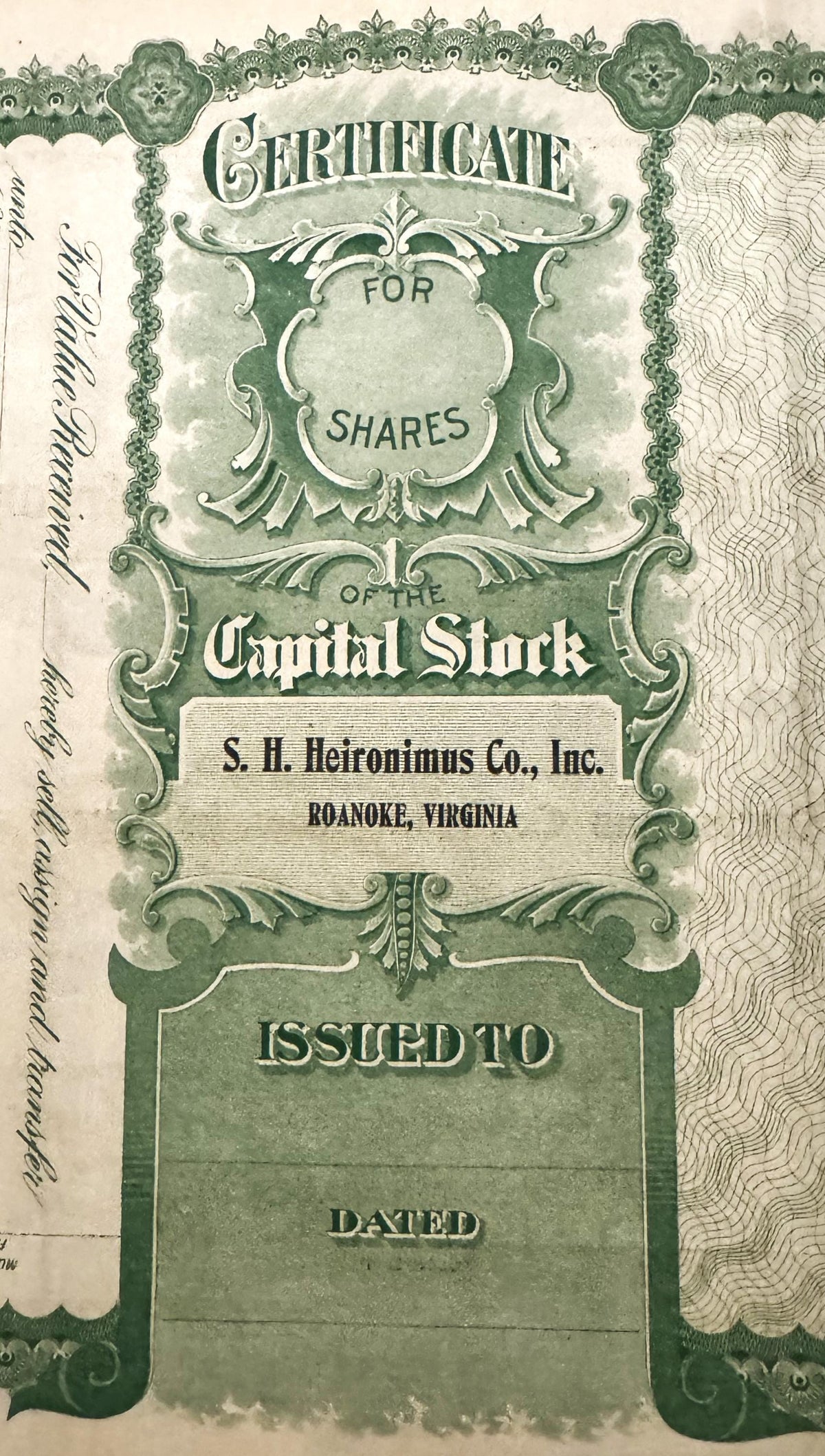 Ornate green and white stock certificate for S.H. Heironimus Co., Inc. of Roanoke, Virginia with decorative borders and blank